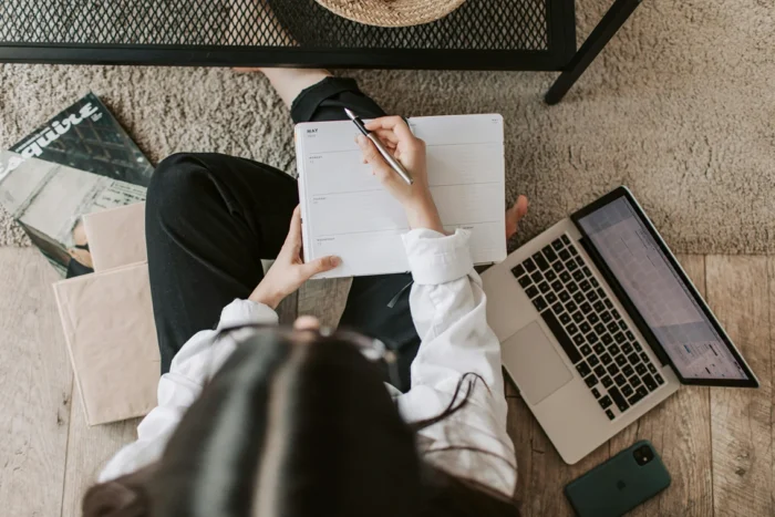 A student creating a study planner in their diary, StudySmarter Magazine